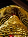 Multiple Large Yellow Incense Coils Hanging In Stacks From The Ceiling In A Chinese Temple