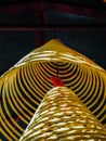 Multiple Large Yellow Incense Coils Hanging In Stacks From The Ceiling In A Chinese Temple