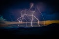 Multiple lightning strikes on distant mountain Royalty Free Stock Photo