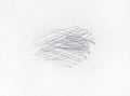 Multiple linear pencil scratches on blank paper surface.