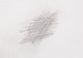 Multiple linear pencil scratches on blank paper surface.