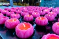 Multiple lotus shaped candle lighted up in temple for prayer