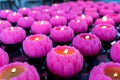 Multiple lotus shaped candle lighted up in temple for prayer