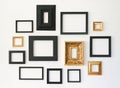 Multiple many blank small picture frames on white wall Royalty Free Stock Photo