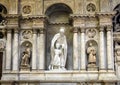 Multiple marble statues of saints on a wall in the Genoa Cathedral Royalty Free Stock Photo
