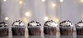Multiple mini cupcakes with lights background
