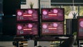 Multiple monitors with critical error message flashing on screens with hacking alert Royalty Free Stock Photo