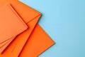 Arrangement of Orange Paper and Envelopes on Blue Background Royalty Free Stock Photo