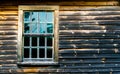 1 multiple paned window in a weathered and charred wooden wall