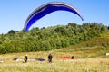 Paragliders are preparing to fly against the backdrop of the beautiful scenery Royalty Free Stock Photo
