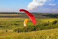 Paragliders are preparing to fly against the backdrop of the beautiful scenery Royalty Free Stock Photo