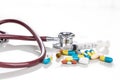 Multiple pills, tablet, caplet, capsule with stethoscope, and syringe. Healthcare concept