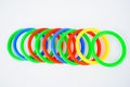 Multiple plastic circle shaped toys arranged on an isolated white background Royalty Free Stock Photo