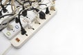 Multiple power socket with connected plugs , Multi plug electrical power strip on a white background , Unsafety concept Royalty Free Stock Photo