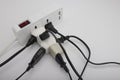Multiple power socket with connected plugs , Multi plug electrical power strip on a white background , Unsafety concept Royalty Free Stock Photo