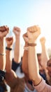 Multiple raised fists reaching towards a bright sunny sky, symbolizing strength and unity. Royalty Free Stock Photo