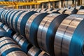 multiple rows of galvanized steel coils neatly stored in a large industrial warehouse Royalty Free Stock Photo