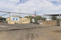 Multiple safety and security warning signs, including hazardous chemicals, on the barbed wire fence of an industrial business site Royalty Free Stock Photo