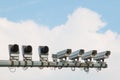 Multiple security cameras and cloudy sky