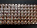 Multiple used AA alkaline batteries are seen in a pile. Close-up front view from the plus side of the battery Royalty Free Stock Photo