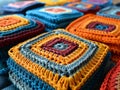 Multiple vibrant crocheted squares arranged in rows, highlighting their intricate patterns.