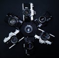 Multiple Vintage cameras over black leather - Zenithal View