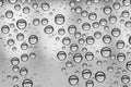 Multiple water drops or raindrops of different sizes on a window glass Royalty Free Stock Photo