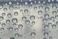 Multiple water drops or raindrops of different sizes on a window glass Royalty Free Stock Photo