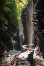 Multiple waterfalls on the Gorge trail in Watkins Glen state park, New York. Sunlight reflections on the wet rocky bank Royalty Free Stock Photo