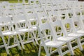 Multiple white folding chairs for event. Outdoor city wedding Royalty Free Stock Photo