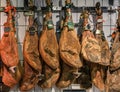 Whole legs of serrano iberico ham on display at a local market in Madrid, Spain