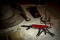 Multipurpose knife, compass, money and hat on an old map Royalty Free Stock Photo