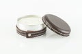 Multipurpose metal container decorated with leather. Used as a candle; photo on white background