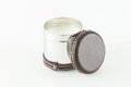 Multipurpose metal container decorated with leather. Used as a candle; photo on white background