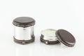 Multipurpose metal container decorated with leather. Used as a candle; photo on white background