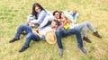 Multiracial best friends having fun at meadow picnic - Happy friendship fun concept with young people millenials sharing time Royalty Free Stock Photo