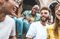 Multiracial best friends laughing together hanging out on city street Royalty Free Stock Photo