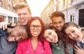 Multiracial best friends taking selfie outdoors in urban contest - Happy young people having fun together - Multi ethnic and Royalty Free Stock Photo