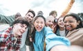 Multiracial best friends taking selfie picture with smart mobile phone outside Royalty Free Stock Photo