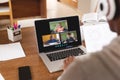 Multiracial boy looking at students on laptop screen while attending online lecture from home Royalty Free Stock Photo