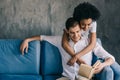 Multiracial boyfriend and girlfriend discussing book together