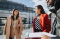 Multiracial business colleagues discussing work outside modern office building Royalty Free Stock Photo