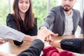 Multiracial business people collapse stacking hands over work table in modern meeting room.Teamwork join hands support together in Royalty Free Stock Photo