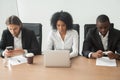 Multiracial business people sitting at office table using corpor Royalty Free Stock Photo