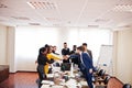 Multiracial business people standing at office and put hands on hands. Diverse group of employees in formal wear Royalty Free Stock Photo