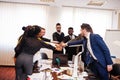 Multiracial business people standing at office and put hands on hands. Diverse group of employees in formal wear Royalty Free Stock Photo