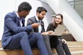 Multiracial business people in suit working with laptop on site outdoors Royalty Free Stock Photo