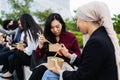 Multiracial business people taking a break eating a meal outside office Royalty Free Stock Photo