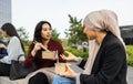 Multiracial business women taking a break for eating a meal outside office Royalty Free Stock Photo