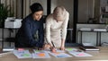 Multi racial businesswomen working on project statistics in office Royalty Free Stock Photo